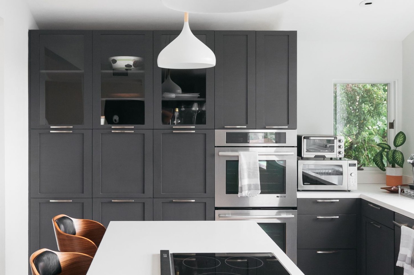5 Ways to Style Gray Kitchen Cabinets - grey kitchen cabinets with black countertops